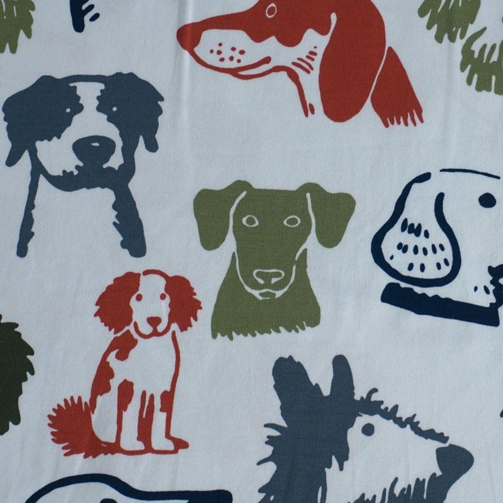 Baumwolljersey Hundeköpfe grün blau rostorange auf weiß